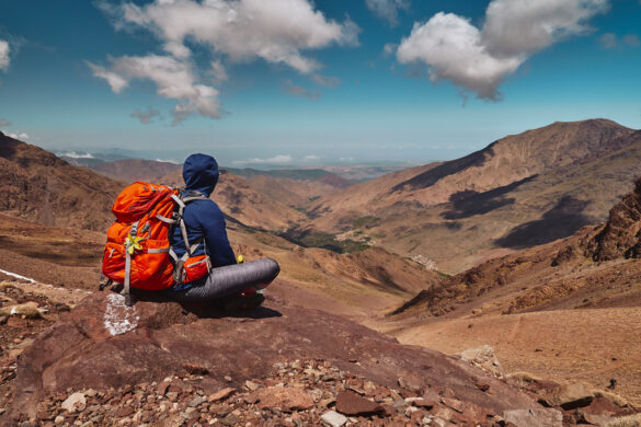 Tourist,Girl,On,The,Hike,Sitting,On,The,Rock,In